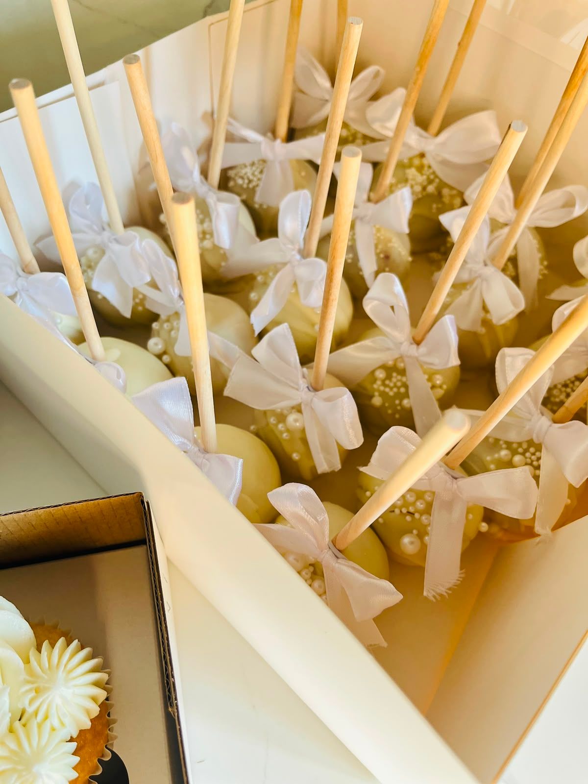 Pearl Bow Cake Pops by Baked by Buhlebenkosi